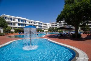 a fountain in the middle of a swimming pool at Lucky Star Marina Apartment, with Pool in Lagos