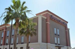 a building with palm trees in front of it at Hampton Inn and Suites Houston-Katy in Katy
