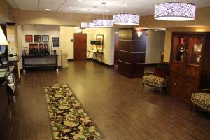 a lobby with a waiting area with chairs and a table at Hampton Inn and Suites Houston-Katy in Katy