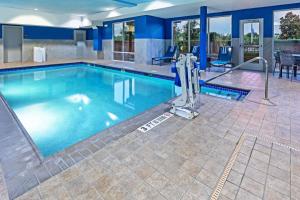 a swimming pool with blue water in a building at Hampton Inn and Suites Houston Central in Houston