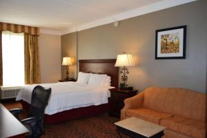a hotel room with a bed and a couch at Hampton Inn and Suites Houston-Katy in Katy