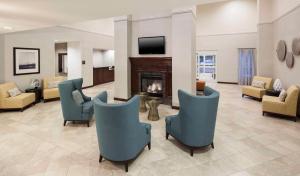 a waiting room with chairs and a fireplace at Homewood Suites by Hilton Houston Stafford Sugar Land in Stafford