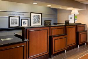 a lobby with a reception desk in a hospital at Hampton Inn Houston Stafford in Stafford
