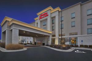 a hotel building with a sign on the front of it at Hampton Inn & Suites Wichita-Northeast in Wichita