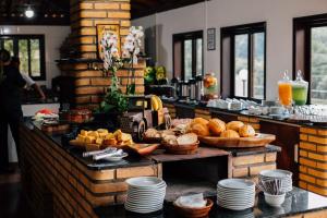 a breakfast buffet with bread and pastries on a table at Espaço Villa Verde in Ibiúna