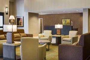 a lobby with couches chairs and tables and lamps at Homewood Suites by Hilton Coralville - Iowa River Landing in Coralville