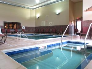 a pool in a hotel room with a swimming pool at Homewood Suites by Hilton Coralville - Iowa River Landing in Coralville