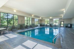 a large swimming pool in a building with windows at Hampton Inn and Suites Indianapolis/Brownsburg in Brownsburg