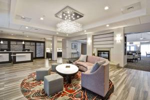 a lobby with a couch and chairs and a table at The Homewood Suites by Hilton Ithaca in Ithaca