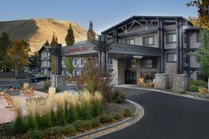 a hotel building with a mountain in the background at Hampton Inn Jackson Hole in Jackson