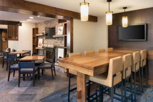 una sala da pranzo con un grande tavolo in legno e sedie di Hampton Inn Jackson Hole a Jackson