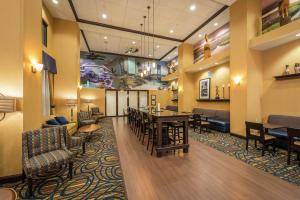 a lobby with a waiting room with tables and chairs at Hampton Inn & Suites Jacksonville South - Bartram Park in Jacksonville