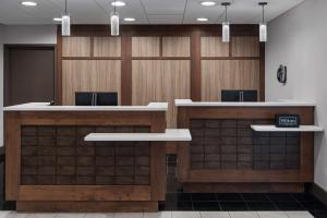 a lobby with wood paneling and a waiting room at Homewood Suites by Hilton Carle Place - Garden City, NY in Carle Place