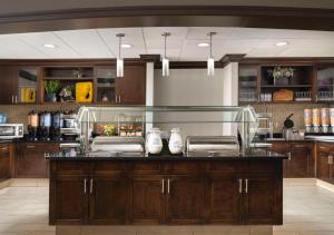 a kitchen with a counter with shoes on it at Homewood Suites by Hilton Carle Place - Garden City, NY in Carle Place