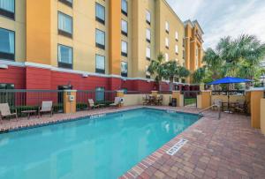 a swimming pool in front of a building with a hotel at Hampton Inn & Suites Jacksonville South - Bartram Park in Jacksonville