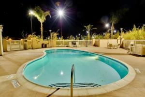 a large swimming pool at night with lights at Hampton Inn & Suites Moreno Valley in Moreno Valley