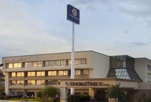 a building with a blue sign in front of it at DoubleTree by Hilton Fayetteville in Fayetteville