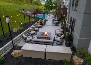 an outdoor patio with chairs and a fire pit at Hampton Inn Johnstown in Geistown