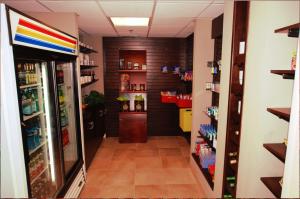 a hallway of a store with a refrigerator at DoubleTree by Hilton Fayetteville in Fayetteville