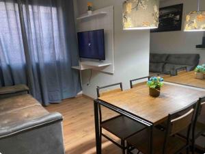 a living room with a wooden table and chairs at Apto Aconchegante in Votorantim