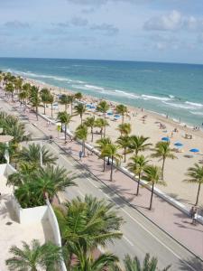 a view of a beach with palm trees and the ocean at GALLERY One - A DoubleTree Suites by Hilton Hotel in Fort Lauderdale