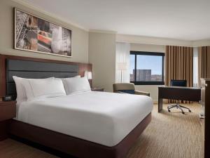 a hotel room with a large bed and a desk at DoubleTree by Hilton Fort Lee/George Washington Bridge in Fort Lee