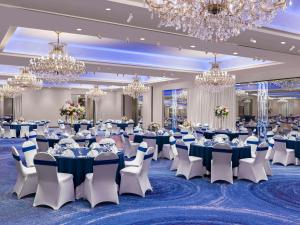 a ballroom with tables and chairs and chandeliers at DoubleTree by Hilton Fort Lee/George Washington Bridge in Fort Lee