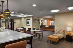 a waiting room with tables and chairs in a hospital at Hampton Inn Greenville/Travelers Rest in Travelers Rest