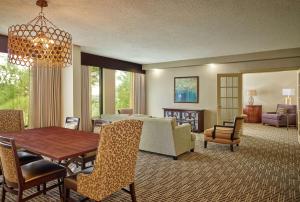 a living room with a table and a dining room at DoubleTree by Hilton Houston Intercontinental Airport in Houston