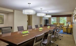 a conference room with a large wooden table and chairs at DoubleTree by Hilton Houston Intercontinental Airport in Houston