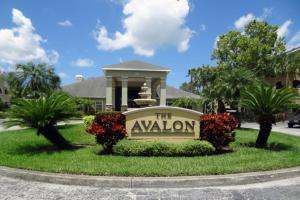 a sign in the grass in front of a building at The Avalon in Clearwater
