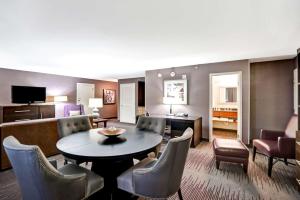 a living room with a table and chairs at DoubleTree by Hilton Downtown Wilmington - Legal District in Wilmington