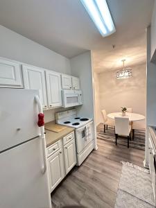 a kitchen with a white refrigerator and a table at The Avalon in Clearwater