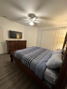 a bedroom with a bed and a ceiling fan at The Avalon in Clearwater +10 photos