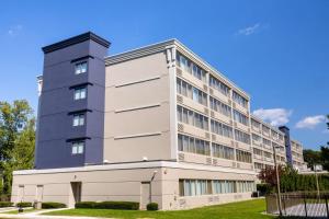 a tall white building with a blue at DoubleTree by Hilton Tinton Falls-Eatontown in Tinton Falls