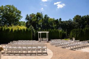 a row of chairs and a gazebo at a wedding at DoubleTree by Hilton Tinton Falls-Eatontown in Tinton Falls