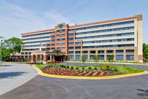 a large office building with flowers in front of it at Homewood Suites by Hilton Gaithersburg/Washington, DC North in Gaithersburg