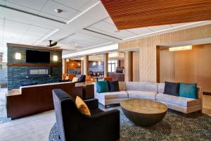 a living room with a couch and a table and chairs at Homewood Suites by Hilton Gaithersburg/Washington, DC North in Gaithersburg