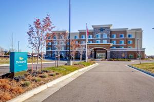 a building with a sign in front of a street at Homewood Suites by Hilton Greeley in Greeley