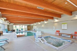 a pool in a building with a swimming pool at Home2 Suites by Hilton Idaho Falls in Idaho Falls