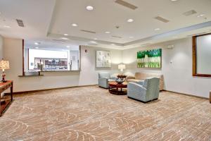 a lobby with two chairs and a couch and a table at Homewood Suites by Hilton Greeley in Greeley