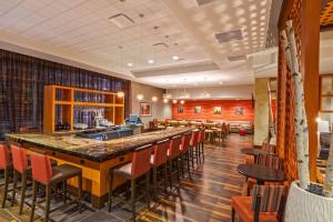 a bar in a restaurant with red chairs at Homewood Suites by Hilton Houston Downtown in Houston