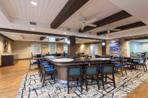 a dining room with a bar and chairs at Homewood Suites by Hilton Grand Rapids Downtown in Grand Rapids