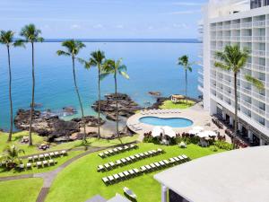 a view of the ocean from the balcony of a resort at Grand Naniloa Hotel, a Doubletree by Hilton in Hilo