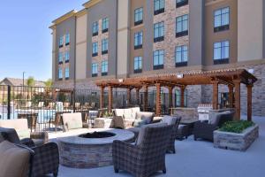 a patio with a fire pit in front of a building at Homewood Suites by Hilton Trophy Club Fort Worth North in Trophy Club