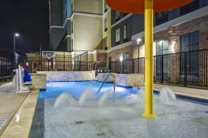 a water slide in a pool in a building at Homewood Suites By Hilton Galveston in Galveston