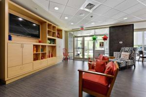 a living room with a couch and a tv at Home2 Suites by Hilton Gulfport I-10 in Gulfport