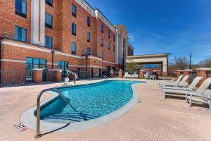 a swimming pool with lounge chairs next to a building at Hampton Inn & Suites - Hartsville, SC in Hartsville
