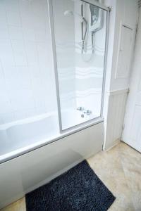 a bathroom with a shower with a glass door at Fitzwilliam House -3 Bed House in Redcar