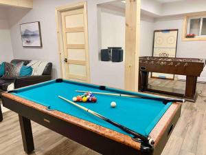 a living room with a pool table in a room at Lake Orignal Waterfront SPA Pool Tremblant SKI in Val-des-Lacs